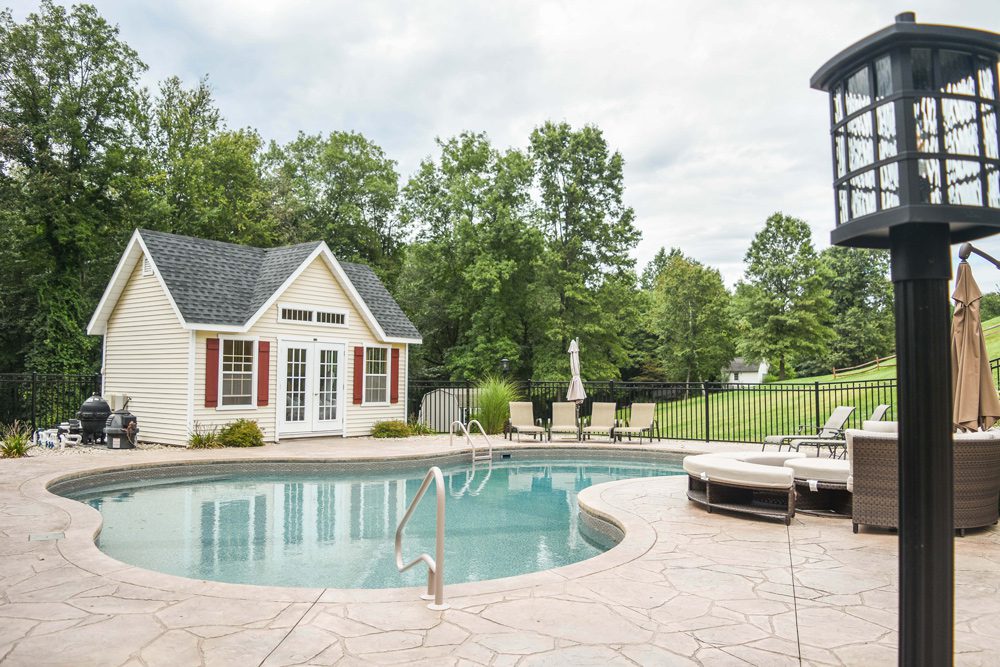 This is a photo of an in ground pool with custom pool house