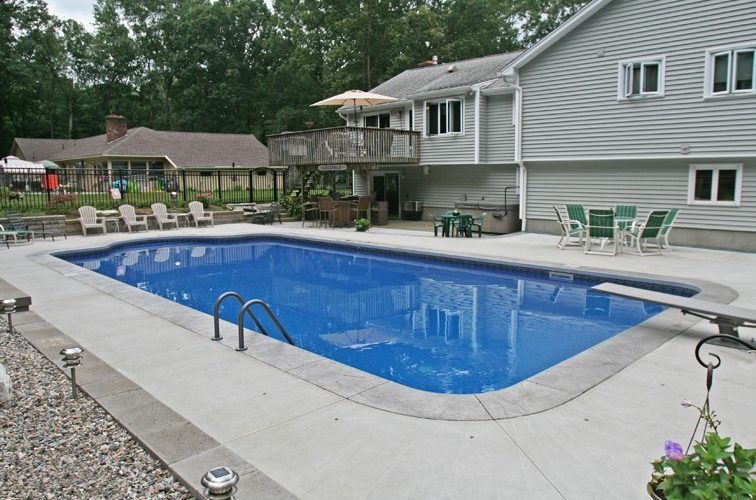This is a photo of a patrician in ground pool in Saugerties, NY diving board and fence in backyard.