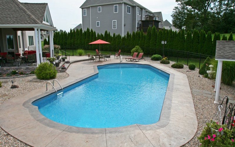This is a photo of a Lazy L style custom inground swimming pool