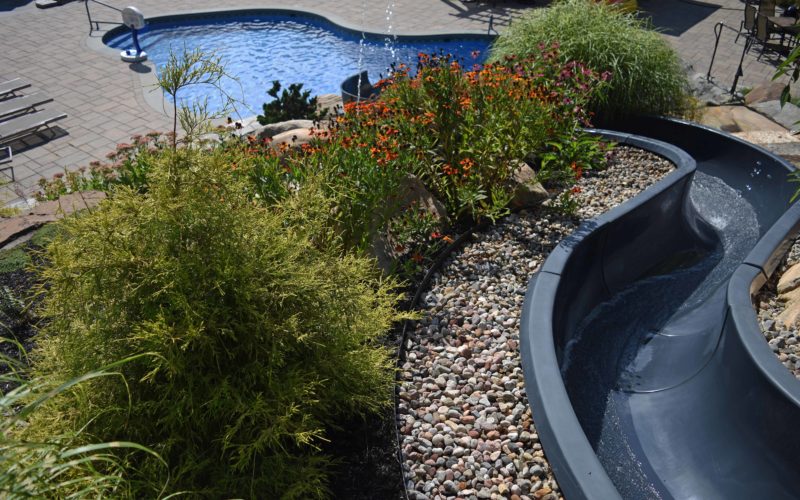 Custom inground pool with slide installed by Majestic Pools