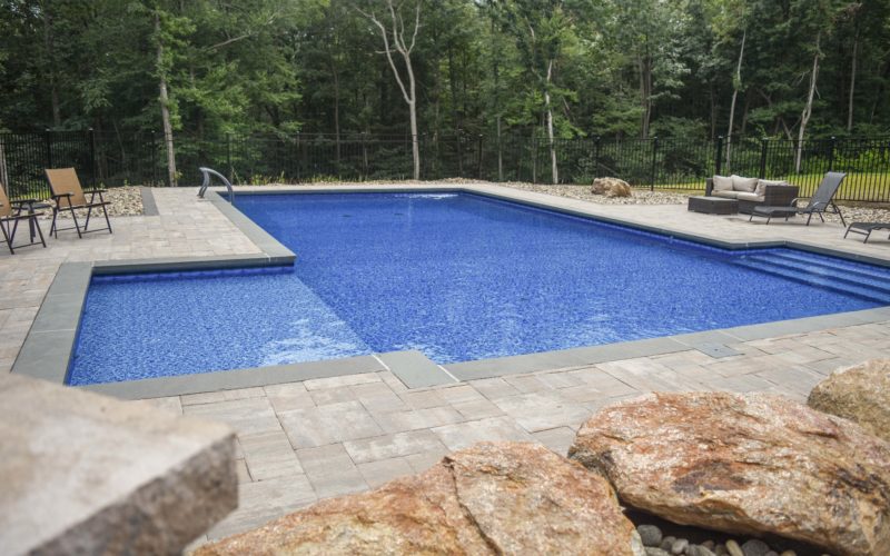 Custom L- shaped inground pool installed by Majestic Pools