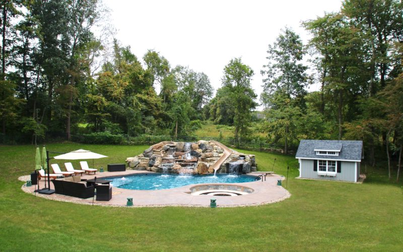 Custom inground pool with slide installed by Majestic Pools